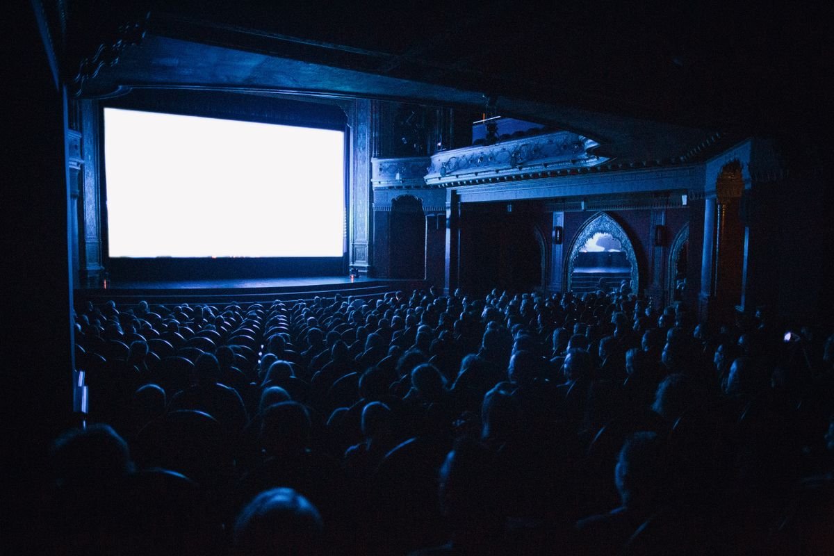 Audience filling a cinema hall during an evening screening